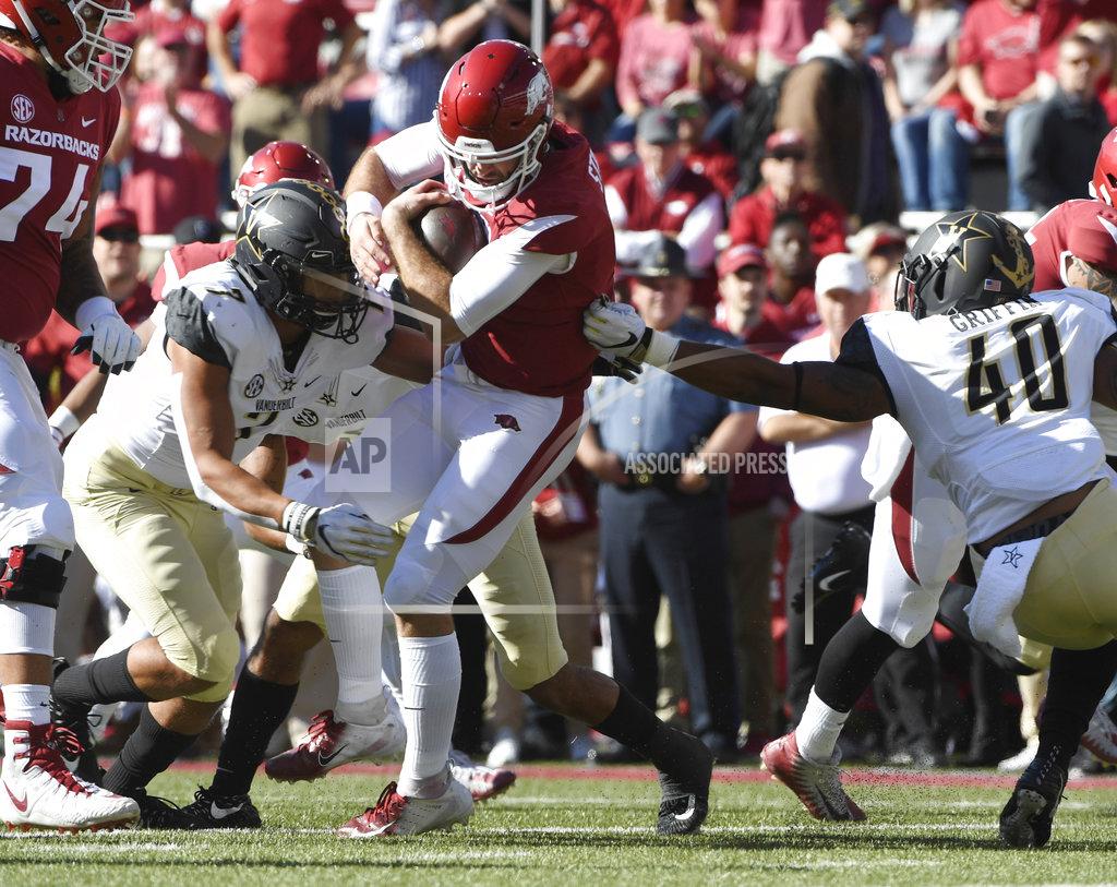 Michael Woods Arkansas quarterback Ty Storey is taken down by Vanderbilt defenders Dimitri Moore (7) and Jordan Griffin (40) in the first half of an NCAA college football game Saturday, Oct. 27, 2018, in Fayetteville, Ark. (AP Photo/Michael Woods)