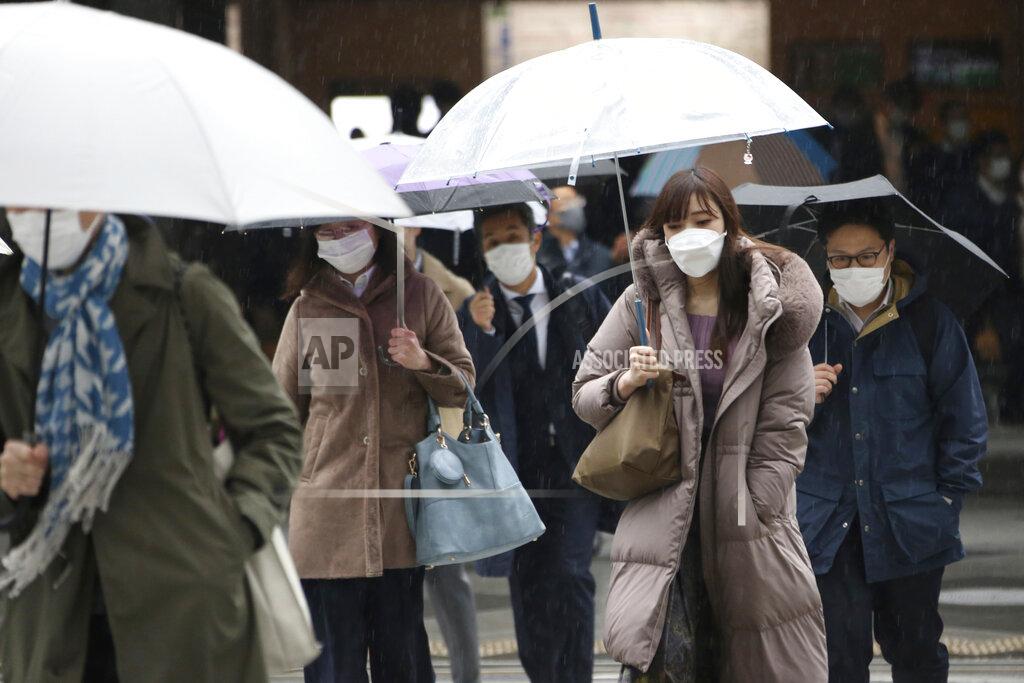Koji Sasahara People wearing face masks to protect against the spread of the coronavirus walk at a crossing in Tokyo, Monday, Feb. 15, 2021. Tokyo is under state of emergency as the government seeks to stop a surge of new coronavirus infections. (AP Photo/Koji Sasahara)