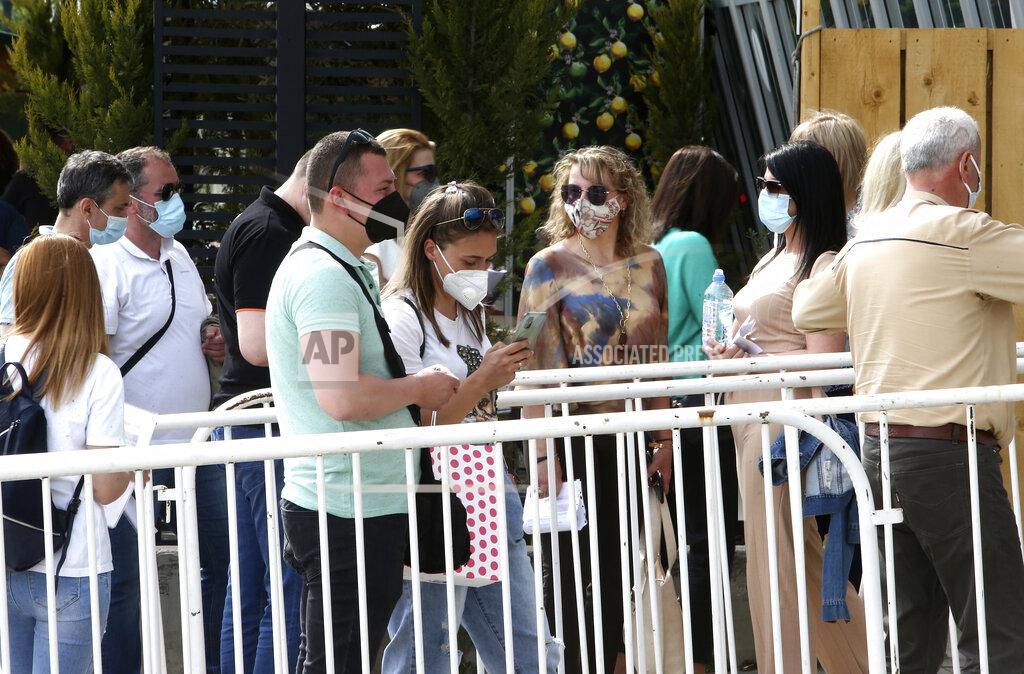 Boris Grdanoski People wait in line to enter the COVID-19 vaccination center, at A1 Arena in Skopje, North Macedonia, on Tuesday, May 4, 2021. The European Union started delivering EU-funded coronavirus vaccines Tuesday to the Balkans, a region that wants to join the 27-nation bloc but where China and Russia have already been supplying the much-needed shots and making political gains. (AP Photo/Boris Grdanoski)