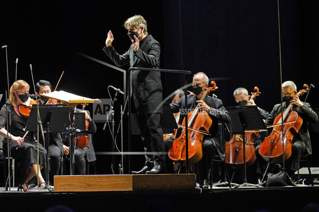 Kathy Willens CORRECTS SPELLING OF FIRST NAME TO ESA INSTEAD OF ESSA - Guest conductor Esa-Pekka Salonen, music director of the San Francisco Symphony and principal conductor of London's Philharmonia Orchestra, leads the New York Philharmonic as the orchestra performs before a live audience of 150 people for the first time since March 10, 2020, at The Shed in Hudson Yards, Wednesday, April 14, 2021, in New York. (AP Photo/Kathy Willens)