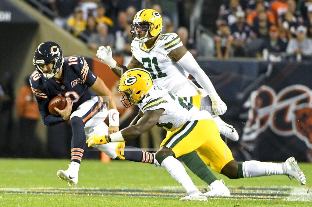 David Banks Chicago Bears' Mitchell Trubisky runs past Green Bay Packers' Raven Greene and Preston Smith during the first half of an NFL football game Thursday, Sept. 5, 2019, in Chicago. (AP Photo/David Banks)