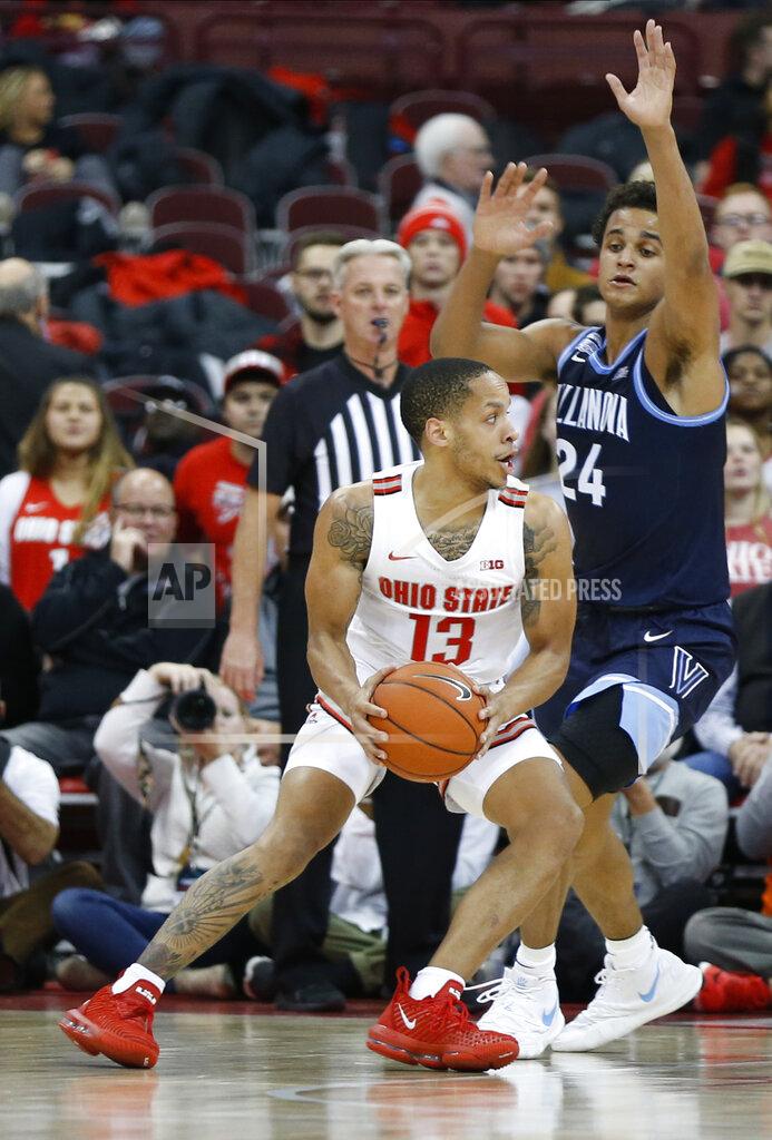 Jay Laprete Ohio State's C.J. Walker, left, looks to pass the ball as Villanova's Jeremiah Robinson-Earl defends during the first half of an NCAA college basketball game Wednesday, Nov. 13, 2019, in Columbus, Ohio. (AP Photo/Jay LaPrete)