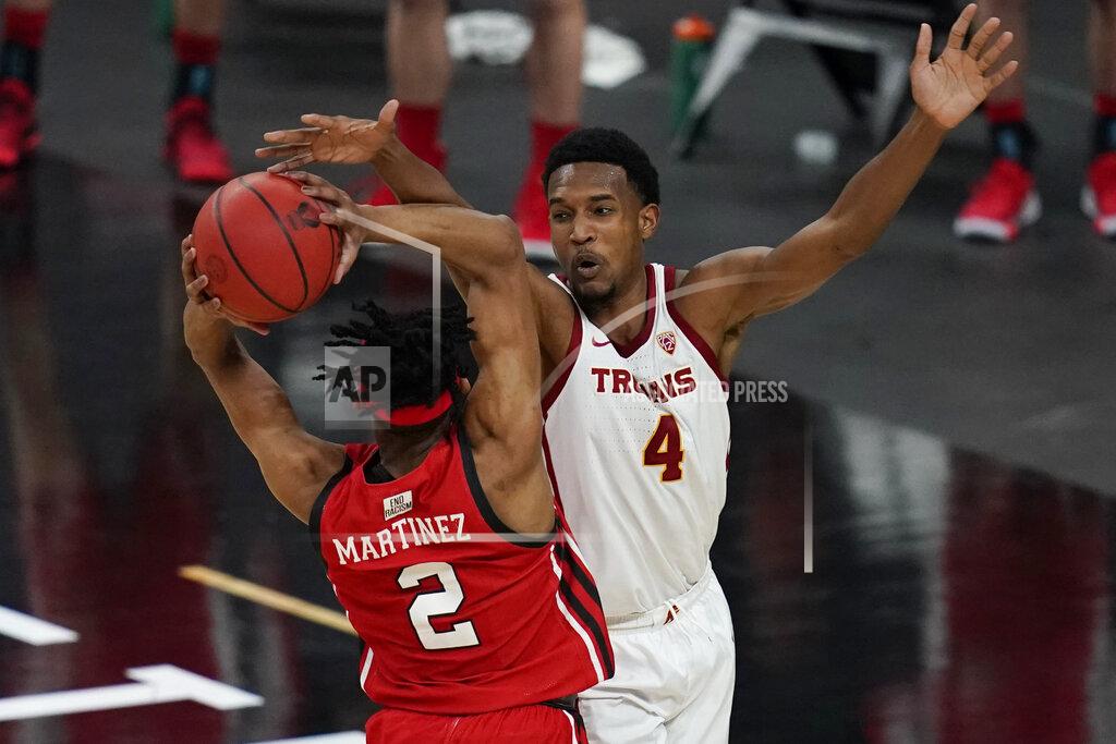 John Locher Southern California's Evan Mobley (4) guards Utah's Ian Martinez (2) during the second half of an NCAA college basketball game in the quarterfinal round of the Pac-12 men's tournament Thursday, March 11, 2021, in Las Vegas. (AP Photo/John Locher)
