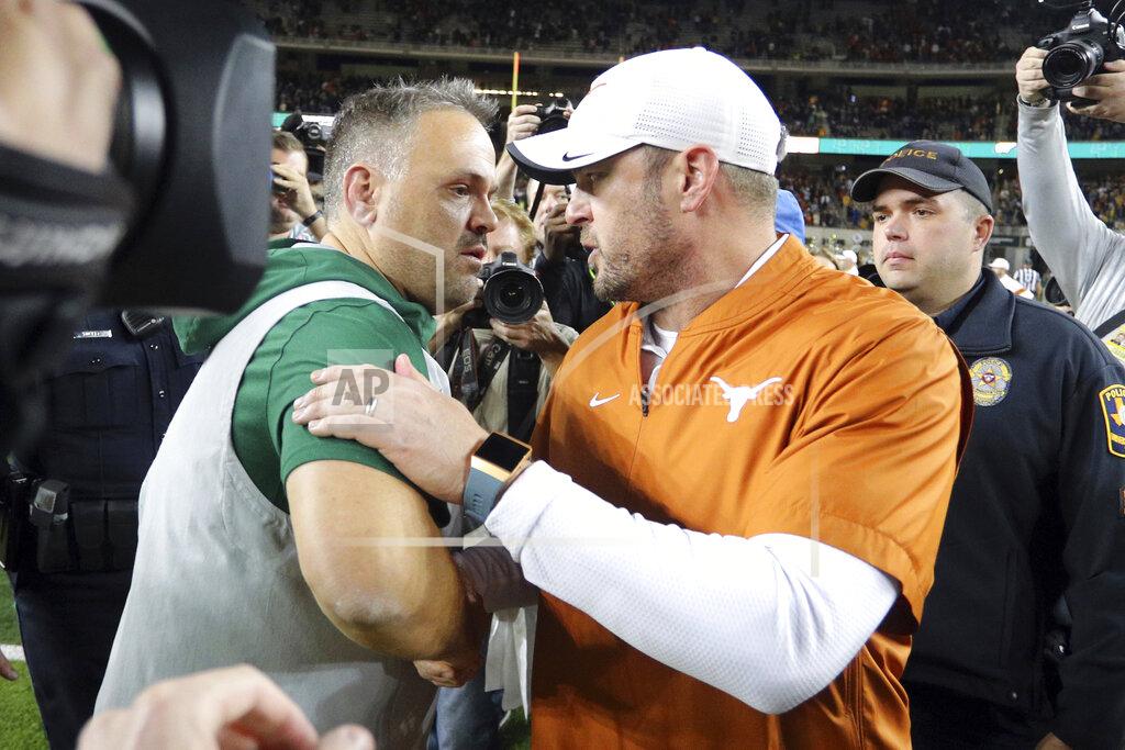 Richard W. Rodriguez Baylor head coach Matt Rhule, left, and Texas head coach Tom Herman shake hands after an NCAA college football game Saturday, Nov. 23, 2019, in Waco, Texas. (AP Photo/Richard W. Rodriguez)
