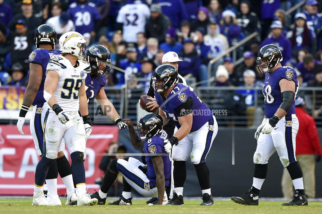 Gail Burton Baltimore Ravens quarterback Lamar Jackson (8) is assisted to his feet after a play in the second half of an NFL wild card playoff football game against the Los Angeles Chargers, Sunday, Jan. 6, 2019, in Baltimore. (AP Photo/Gail Burton)