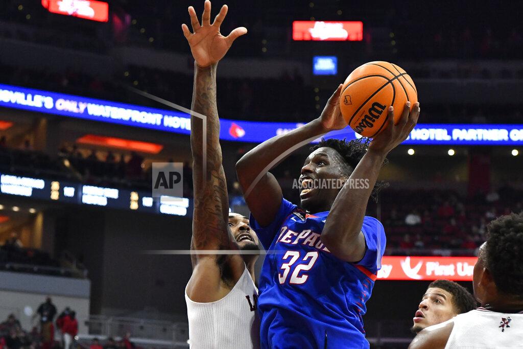 Timothy D. Easley DePaul forward David Jones (32) shoots next to Louisville forward Malik Williams during the first half of an NCAA college basketball game in Louisville, Ky., Friday, Dec. 10, 2021. (AP Photo/Timothy D. Easley)