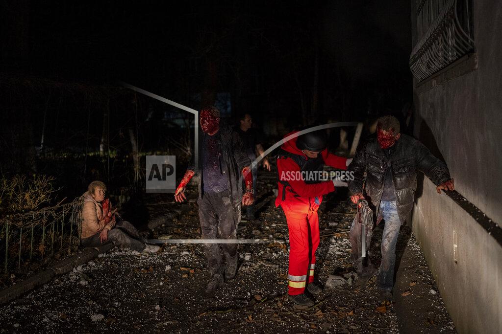 Bernat Armangue A Ukrainian paramedic helps an injured resident moments after a Russian strike in Kherson, southern Ukraine, Thursday, Nov. 24, 2022. (AP Photo/Bernat Armangue)