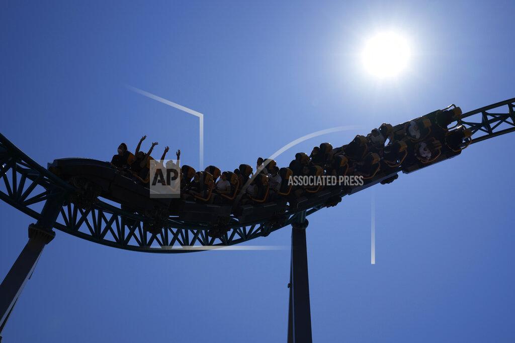 Alessandra Tarantino Visitors enjoy a ride on a roller coaster at Cinecitta World amusement park in the outskirts of Rome in the day of its reopening, Thursday, June 17, 2021. Amusement parks have been closed since Oct. 25 2020, when Italy's second national lockdown started. (AP Photo/Alessandra Tarantino)