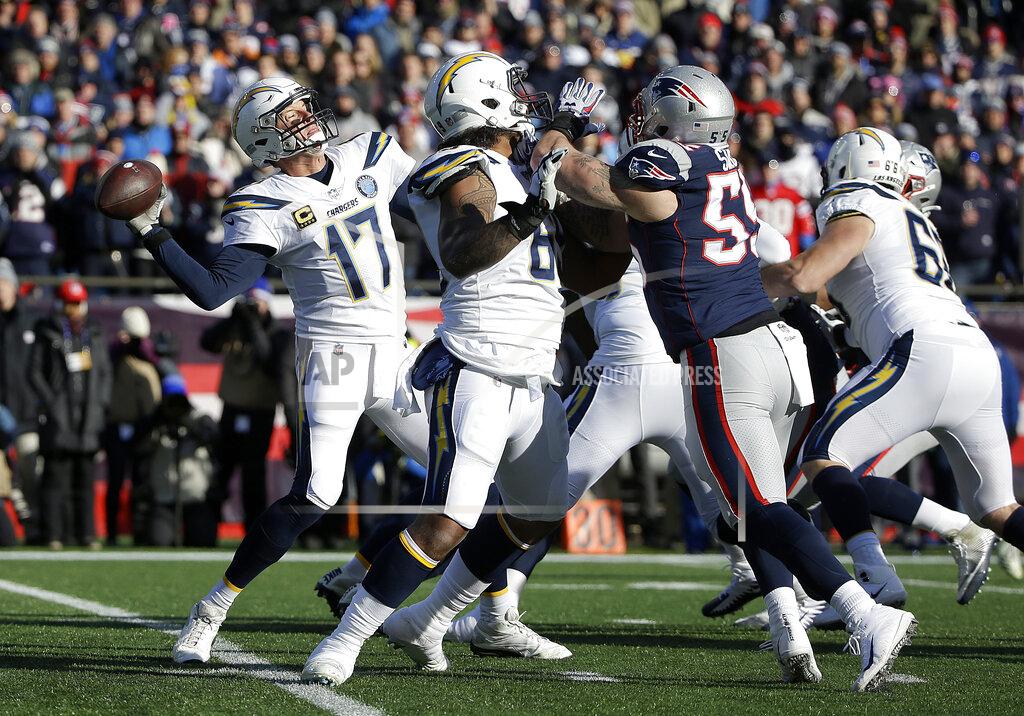 Steven Senne Los Angeles Chargers quarterback Philip Rivers passes under pressure from New England Patriots defensive end John Simon (55) during the first half of an NFL divisional playoff football game, Sunday, Jan. 13, 2019, in Foxborough, Mass. (AP Photo/Steven Senne)