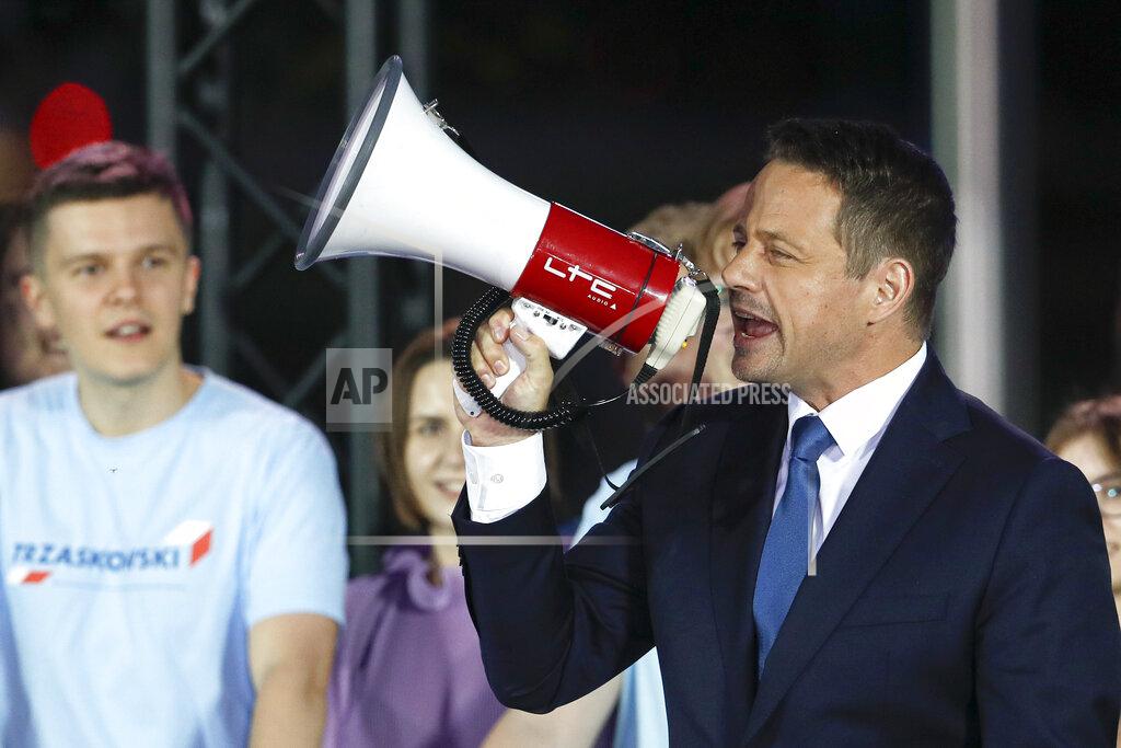 Petr David Josek Presidential candidate Rafal Trzaskowski uses a megaphone while addressing supporters at the end of the election day in Warsaw, Poland, Sunday, July 12, 2020. Voting ended in Poland's razor-blade-close presidential election runoff between the conservative incumbent Andrzej Duda and liberal, pro-European Union Warsaw Mayor Rafal Trzaskowski with exit polls showing the election is too close to call. (AP Photo/Petr David Josek)
