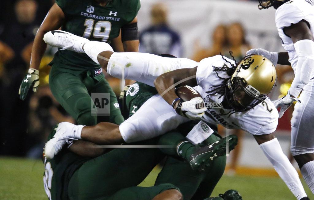 David Zalubowski Colorado wide receiver Laviska Shenault Jr., front, is upended by Colorado State Rams linebacker Trey Sutton after catching a pass for a short gain in the first half of an NCAA college football game Friday, Aug. 31, 2018, in Denver. (AP Photo/David Zalubowski)
