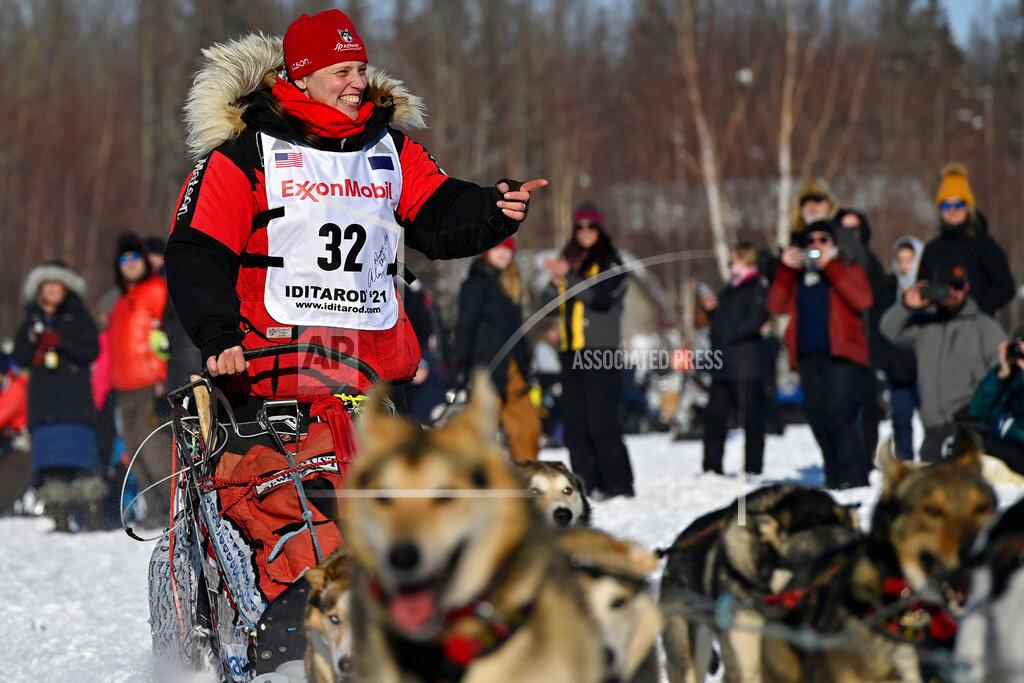 Aliy Zirkle, of Two Rivers, greets fans as she passes by at the Iditarod Sled Dog Race start at Deshka Landing in Willow, Alaska, Sunday, March 7, 2021. (Marc Lester/Anchorage Daily News via AP, Pool)