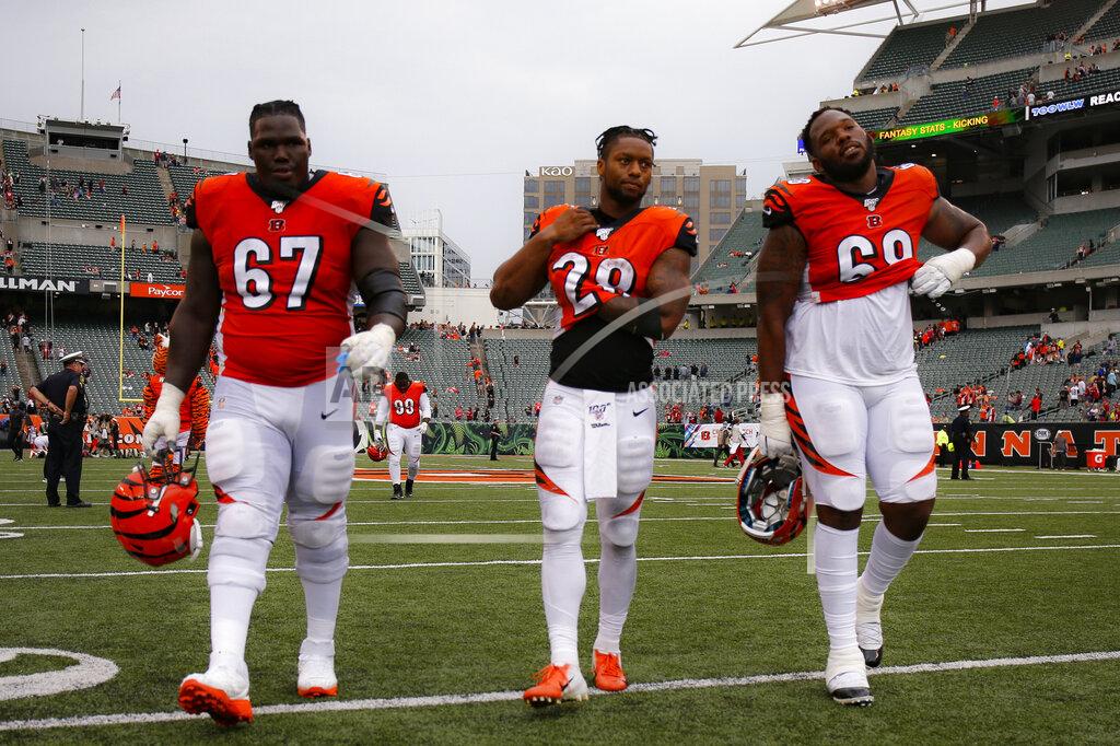 Gary Landers File-This Oct. 6, 2019, file photo shows Cincinnati Bengals offensive guard John Miller (67), running back Joe Mixon (28), and offensive tackle Bobby Hart (68) walking off the field after losing an NFL football game against the Arizona Cardinals, in Cincinnati. Pro football had all sorts of newsworthy topics in 2019. Mobile quarterbacks running dynamic offenses should have been the lead item. Or maybe the fact that teams don't tank, as Miami winning four games displays; forget Cincinnati, the Bengals just are that bad.(AP Photo/Gary Landers,File)