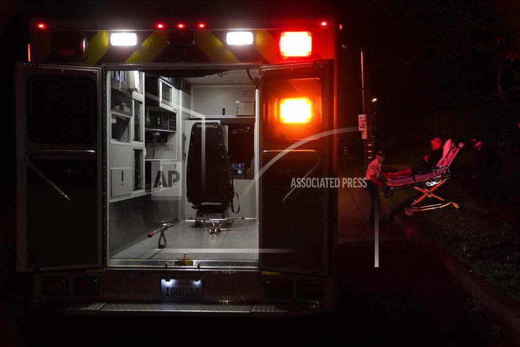 Jae C. Hong Emergency medical technicians Thomas Hoang and Joshua Hammond, of Emergency Ambulance Service, transport a patient on a gurney in Placentia, Calif., Friday, Jan. 8, 2021. EMTs and paramedics have always dealt with life and death — they make split-second decisions about patient care, which hospital to race to, the best and fastest way to save someone — and now they're just a breath away from becoming the patient themselves. (AP Photo/Jae C. Hong)