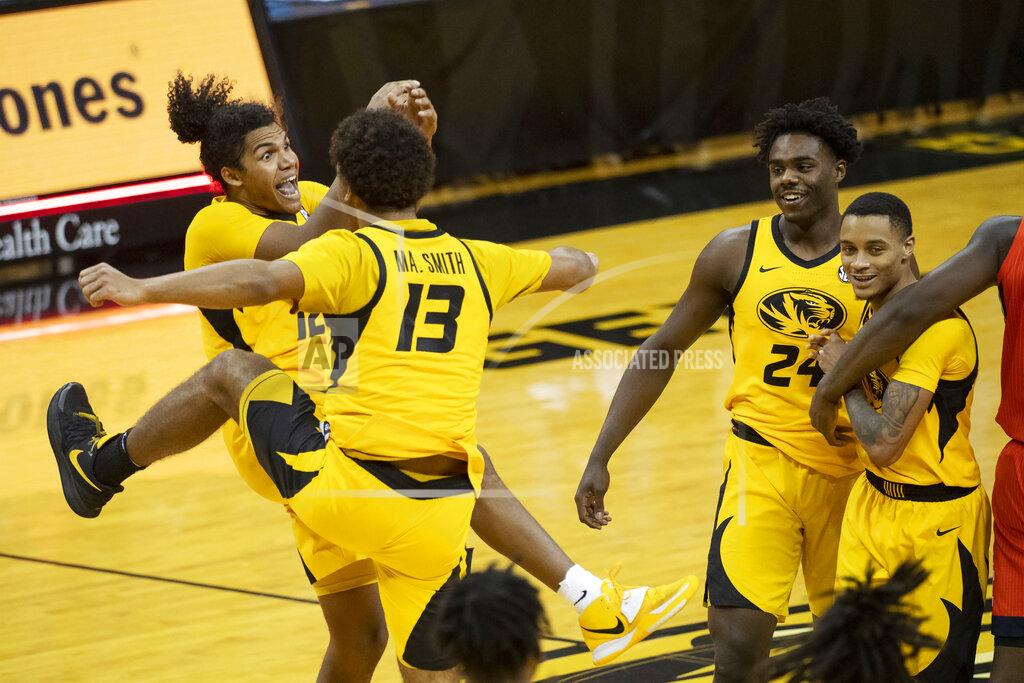 L.g. Patterson Missouri's Dru Smith, Mark Smith, Kobe Brown and Xavier Pinson, form left, celebrate after Missouri defeated Illinois 81-78 in an NCAA college basketball game Saturday, Dec. 12, 2020, in Columbia, Mo. (AP Photo/L.G. Patterson)