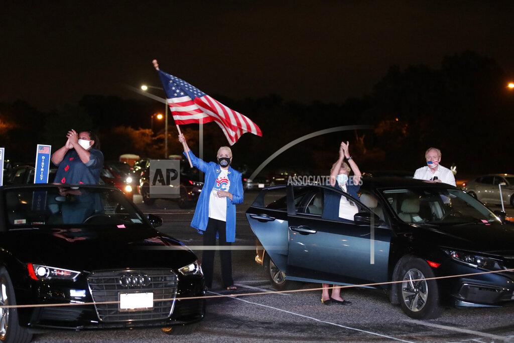 Supporters watch Democratic presidential candidate former Vice President Joe Biden speak, during the final day of the Democratic National Convention, Thursday, Aug. 20, 2020, on a screen at a drive-in theater watch party during the final night of the Democratic National Convention, Thursday, Aug. 20, 2020, in Washington. (AP Photo/Luis M. Alvarez)