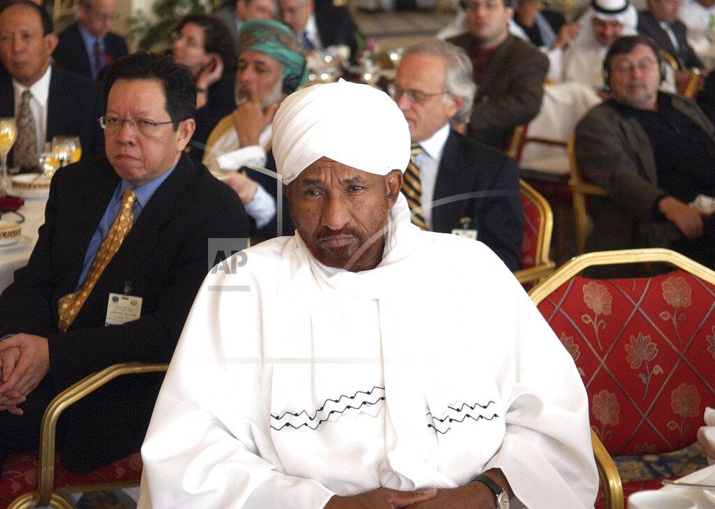 Uncredited FILE - In this April 11, 2005 file photo, former Sudanese Prime Minister and head of the National Umma Party, Sadiq Al-Mahdi attends a US-Islamic World Forum meeting held in Doha, Qatar. Al-Mahdi, 84, died of COVID-19 late on Wednesday, Nov. 25, 2020, at a hospital in the United Arab Emirates, his party said. (AP Photo, File)