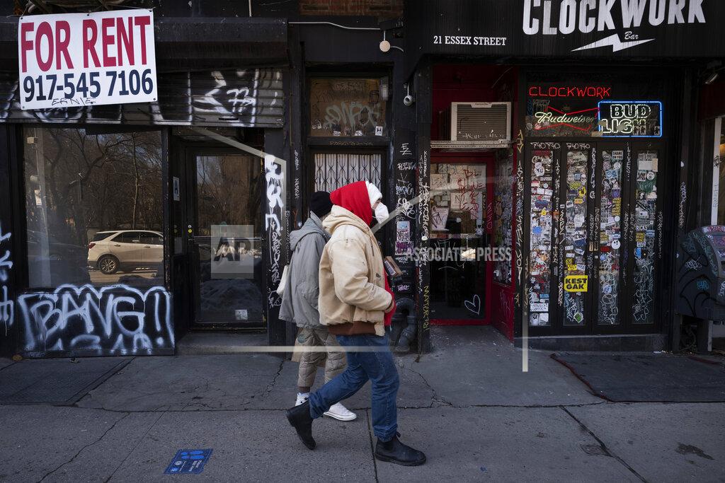 Mark Lennihan FILE - In this Feb. 8, 2021, file photo, a man walks by an empty retail store, left, that is available for rent during the coronavirus pandemic in New York. State governments will get a big influx of federal money from the $1.9 trillion COVID-19 relief package that could suddenly enable them to undertake large, expensive projects that have long been on their to-do lists, including high-speed internet for rural areas and drinking water improvements. (AP Photo/Mark Lennihan, File)