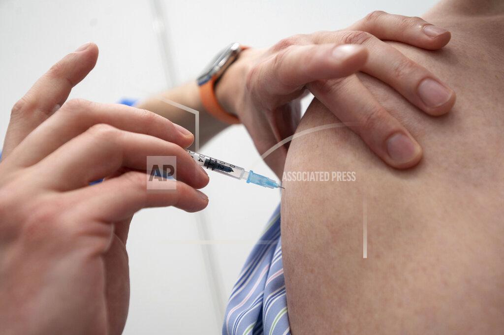Marijan Murat An employee of the Tuebingen Vaccination Centre inoculates a dose of Biontech vaccine in the Paul Horn Arena in Tuebingen, Germany, Wednesday, April 21, 2021. Countries in the European Union have ramped up the vaccination after sluggish start. The uptick comes as countries across Europe also grapple with a rise in infections that has pushed the EU’s overall number of confirmed cases close to 30 million. (Marijan Murat/dpa via AP)