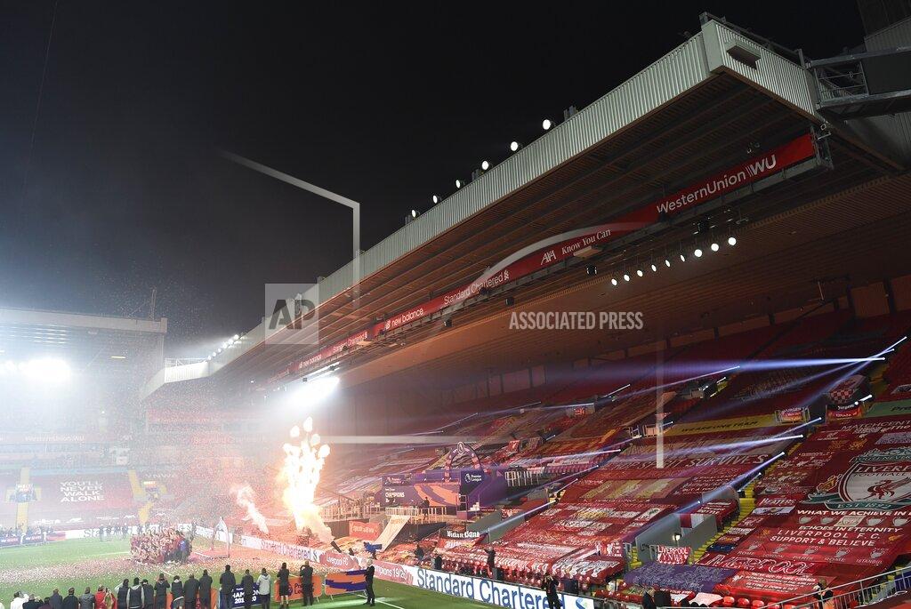 Laurence Griffiths Liverpool players celebrate with the English Premier League trophy following the English Premier League soccer match between Liverpool and Chelsea at Anfield Stadium in Liverpool, England, Wednesday, July 22, 2020. Liverpool are champions of the EPL for the season 2019-2020. The trophy is presented at the teams last home game of the season. Liverpool won the match against Chelsea 5-3. (Laurence Griffiths, Pool via AP)