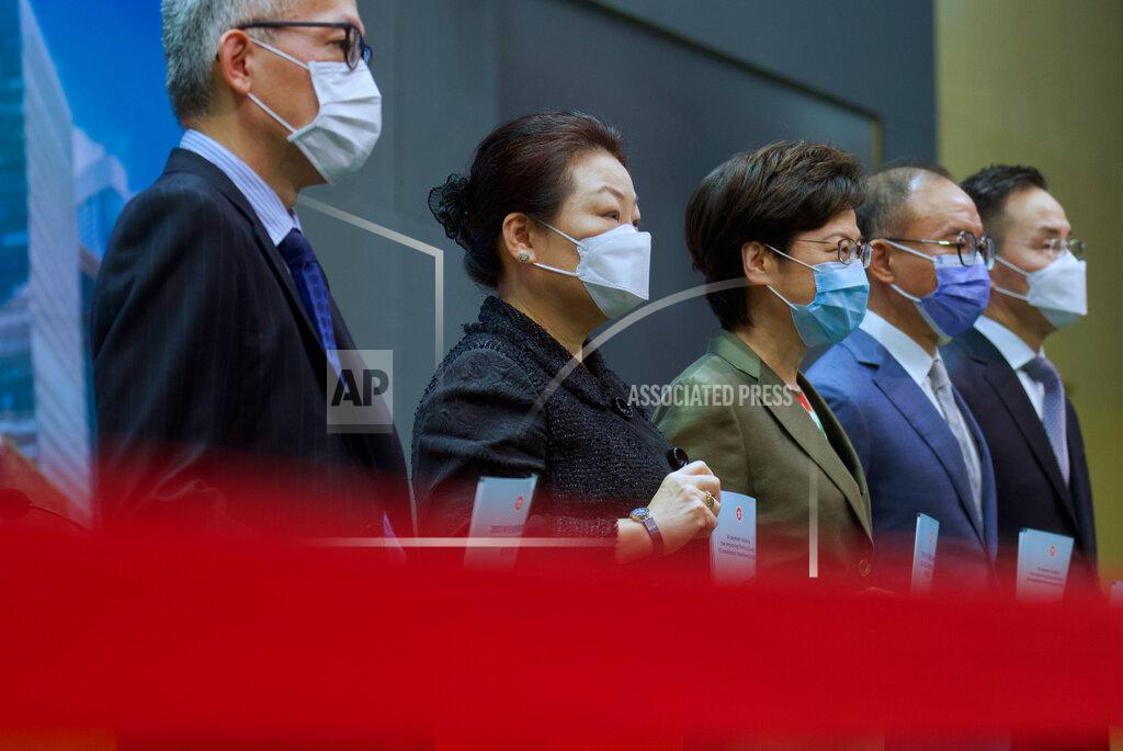 Vincent Yu Hong Kong Chief Executive Carrie Lam, center, poses with other officials before a press conference in Hong Kong, Tuesday, April 13, 2021. Lam said Tuesday that Hong Kong's legislative elections would take place in December, more than a year after they were postponed last year with authorities citing public health risks from the coronavirus pandemic. (AP Photo/Vincent Yu)