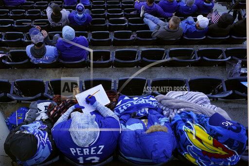 Charlie Riedel A fan keeps score during the first inning of a baseball game between the Kansas City Royals and the Texas Rangers, Thursday, April 1, 2021, in Kansas City, Mo. (AP Photo/Charlie Riedel)