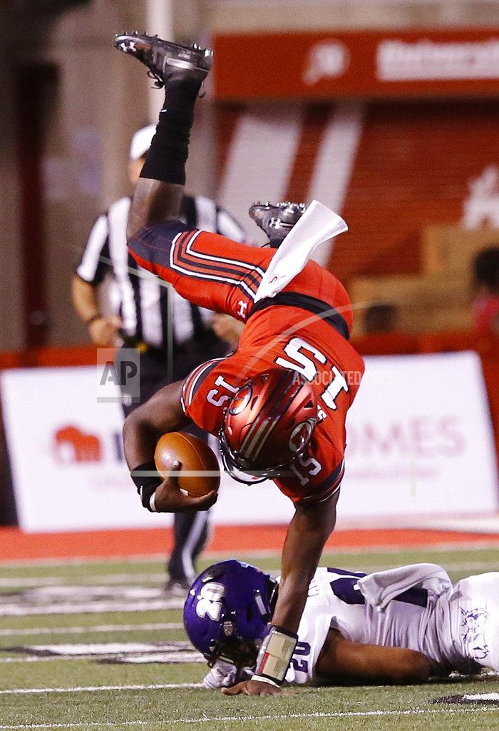 Rick Bowmer FILE - In this Aug. 30, 2018, file photo, Utah's Jason Shelley (15) is up ended by Weber State cornerback Parker Preator (20) in the second half of an NCAA college football game in Salt Lake City. The big question facing Utah when it hosts Oregon is whether Jason Shelley can pick up where Tyler Huntley left off. Shelley, a redshirt freshman, will make his first career start Saturday against the Ducks in place of Huntley, who broke his collarbone late in the third quarter of Utah's 38-20 loss last week to Arizona State. (AP Photo/Rick Bowmer, File)