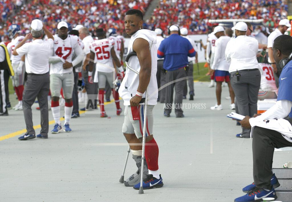 Jason Behnken New York Giants running back Saquon Barkley stands on crutches in the bench area after getting injured against the Tampa Bay Buccaneers during the first half of an NFL football game Sunday, Sept. 22, 2019, in Tampa, Fla. (AP Photo/Jason Behnken)