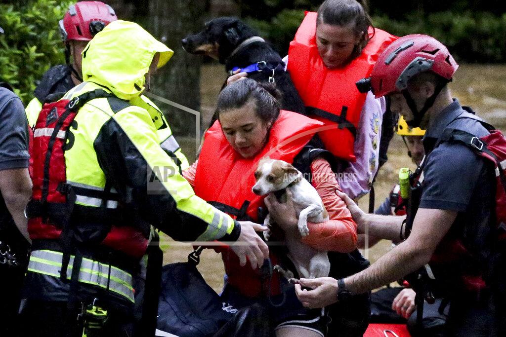 Butch Dill Residents of the Crescent at Lakeshore apartment complex are rescued by Homewood Fire and Rescue as severe weather produced torrential rainfall flooding several apartment buildings Tuesday, May 4, 2021 in Homewood, Ala. (AP Photo/Butch Dill)