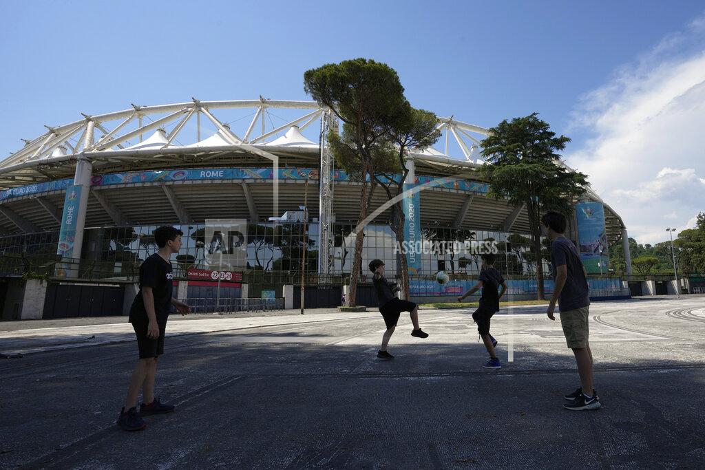 Alessandra Tarantino Boys play soccer in front of Rome's Olympic stadium, Wednesday, June 9, 2021. The Euro 2020 gets underway on Friday June 11 and is being played in 11 host cities across 11 countries. (AP Photo/Alessandra Tarantino)