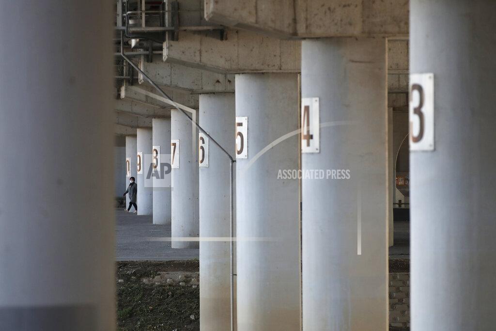 Lee Jin-Man A woman wearing a face mask to help curb the spread of the corona virus walks through an underpass near a stream in Seoul, South Korea, Monday, Nov. 23, 2020. (AP Photo/Lee Jin-man)