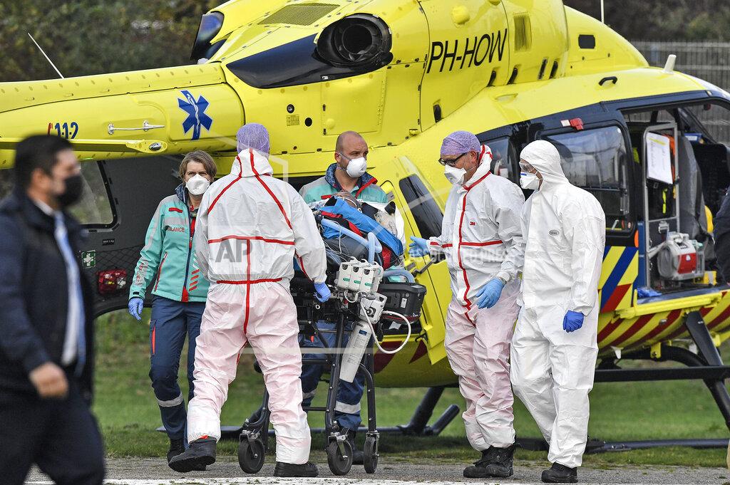 Martin Meissner A COVID-19 patient from the Netherlands arrives for treatment by helicopter to the University hospital in Muenster, Germany, Friday, Oct. 23, 2020. The transfer is intended to reduce the coronavirus pressure on the intensive care units in the Netherlands. (AP Photo/Martin Meissner)