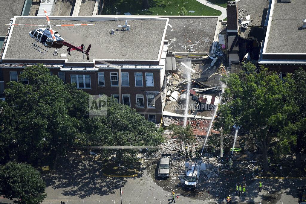 FILE - In this Aug. 2, 2017 file photo, emergency workers respond to an explosion at Minnehaha Academy in Minneapolis. Federal investigators say a pipefitting crew lacked proper training when they moved a gas meter just before a Minneapolis school explosion that killed two people in 2017. The National Transportation Safety Board released its report Monday, Dec. 2, 2019 on the explosion at Minnehaha Academy. (Aaron Lavinsky/Star Tribune via AP, File)