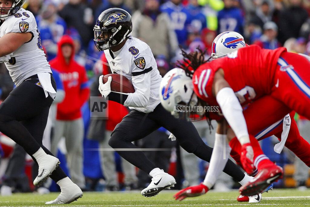 John Munson FILE - Baltimore Ravens quarterback Lamar Jackson (8) carries the ball during the first half of an NFL football game against the Buffalo Bills in Orchard Park, N.Y., in this Sunday, Dec. 8, 2019, file photo. The Bills struggles to stop the run when facing teams with dual-threat quarterbacks in Kansas City's Patrick Mahomes and Arizona's Kyler Murray, resulted in two of Buffalo's three losses this season. Now comes the challenge of attempting to contain Lamar Jackson and the Ravens NFL-leading running attack in an AFC divisional round playoff on Saturday. (AP Photo/John Munson, File)