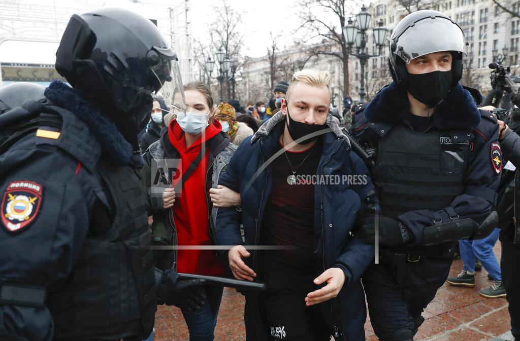 Pavel Golovkin Police detain protesters during a protest against the jailing of opposition leader Alexei Navalny in Moscow, Russia, Saturday, Jan. 23, 2021. Russian police are arresting protesters demanding the release of top Russian opposition leader Alexei Navalny at demonstrations in the country's east and larger unsanctioned rallies are expected later Saturday in Moscow and other major cities.. (AP Photo/Pavel Golovkin)