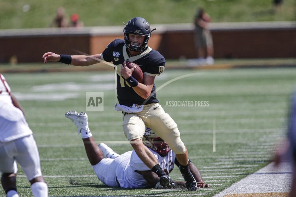 Nell Redmond Wake Forest quarterback Michael Kern (15)avoids Elon defensive lineman Destin Flloyd as he carries the football in the second half of an NCAA college football game in Winston-Salem, N.C., Saturday, Sept. 21, 2019. Wake Forest won 49-7. (AP Photo/Nell Redmond)