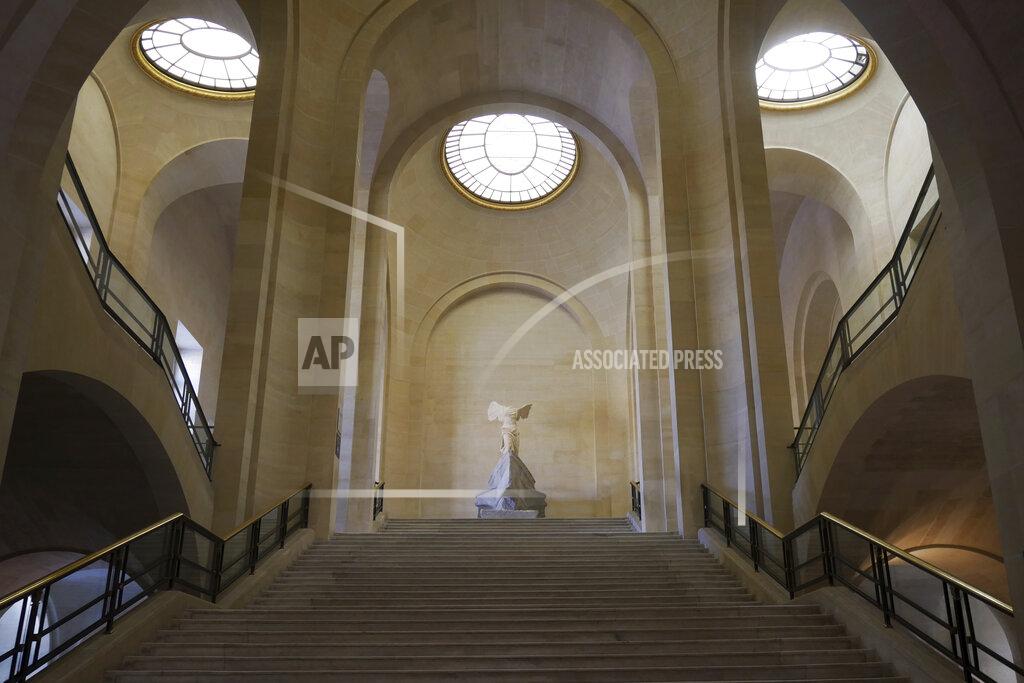 Thibault Camus The Winged Victory of Samothrace sculpture stands at the top of a staircase in a deserted Louvre museum, in Paris, Thursday, Feb. 11, 2021. It's uncertain when the Louvre will reopen, after being closed on Oct. 30 in line with the French government's virus containment measures. But those lucky enough to get in benefit from a rarified private look of collections covering 9,000 years of human history -- with plenty of space to breathe. (AP Photo/Thibault Camus)