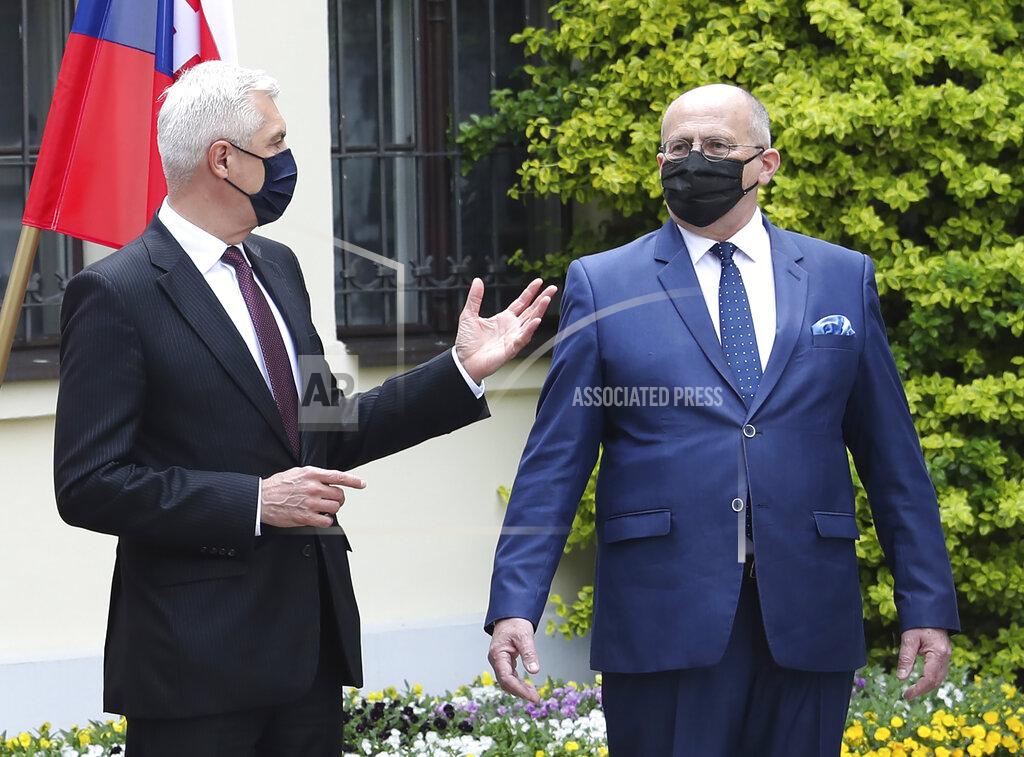 Czarek Sokolowski Poland's Foreign Minister Zbigniew Rau,right, gestures toward Slovak Foreign Minister Ivan Korcok, ahead of a meeting with regional counterparts in Lodz, Poland, Friday, May 14, 2021.(AP Photo/Czarek Sokolowski)