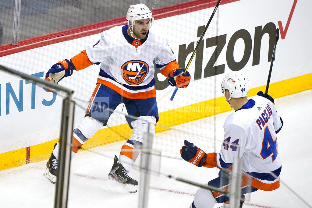 Gene J. Puskar New York Islanders' Kyle Palmieri (21) celebrates with Jean-Gabriel Pageau (44) after scoring during the first period in Game 1 of an NHL hockey Stanley Cup first-round playoff series against the Pittsburgh Penguins in Pittsburgh, Sunday, May 16, 2021. (AP Photo/Gene J. Puskar)