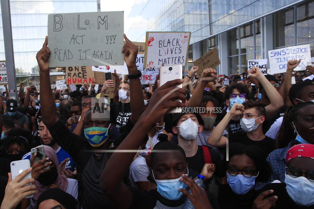 Michel Euler People protest outside the Palace of Justice Tuesday, June 2, 2020 in Paris. French authorities banned the protest over racial injustice and heavy-handed police tactics as global outrage over what happened to George Floyd in the United States kindled frustrations across borders and continents. Family and friends of Adama Traore, a French black man who died shortly after he was arrested by police in 2016, call for a protest which will also pay homage to George Floyd. (AP Photo/Michel Euler)