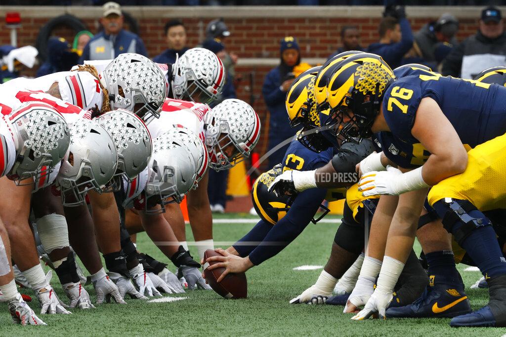 FILE- In this Nov. 30, 2019, file photo, Ohio State, left, and Michigan players line up at the line of scrimmage in the first half of an NCAA college football game in Ann Arbor, Mich. The Big Ten's third football schedule of the 2020 season is highlighted by Michigan-Ohio State on Dec. 12, the final day of the conference's regular-season and the latest date the rivals have ever played.(AP Photo/Paul Sancya, File)