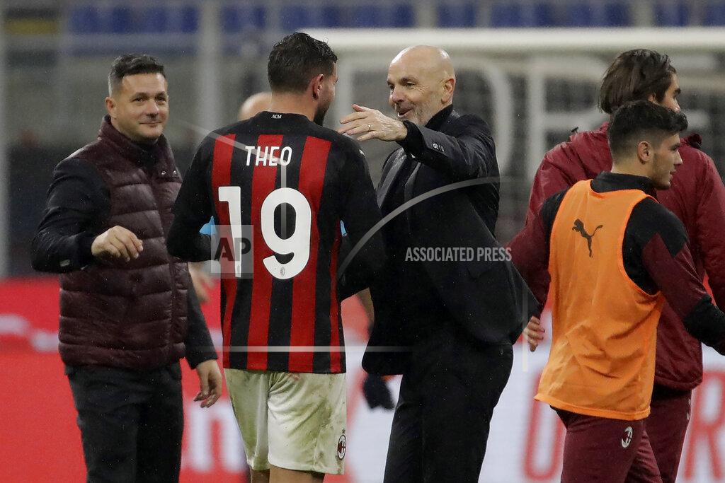 Luca Bruno AC Milan's manager Stefano Pioli congratulate his teammate AC Milan's Theo Hernandez for his goal against Lazio during a Serie A soccer match between AC Milan and Lazio, at the San Siro stadium in Milan, Italy, Wednesday, Dec. 23, 2020. (AP Photo/Luca Bruno)