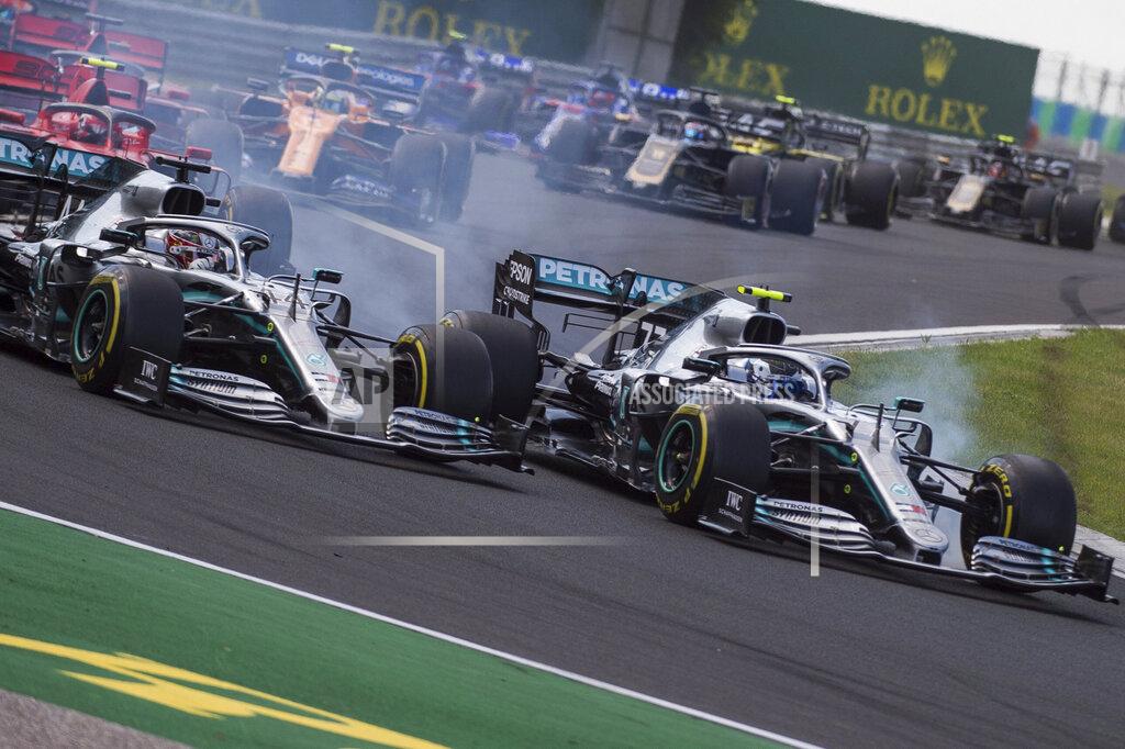 Zoltan Balogh British Forumla One driver Lewis Hamilton of Mercedes, left, and his Finnish teammate Valtteri Bottas steer his car during the Hungarian Formula One Grand Prix at the Hungaroring circuit, in Mogyorod, Hungary, Sunday, Aug. 4, 2019. (Zoltan Balogh/MTI via AP)