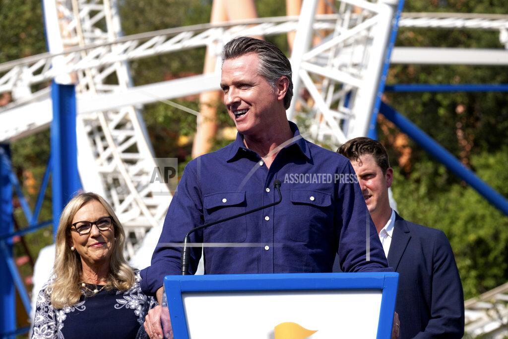 David Crane California Governor Gavin Newsom welcomes the public to Six Flags Magic Mountain in Santa Clarita, Calif., on Wednesday, June 16, 2021. In background are Los Angeles County Supervisor Kathryn Barger and state Sen. Henry Stern. Newsom continued his tour of the state after lifting most COVID-19 restrictions Tuesday. (David Crane/The Orange County Register via AP)