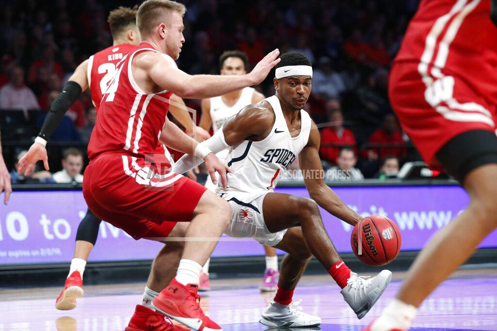 Kathy Willens Richmond guard Blake Francis (1) drives around Wisconsin guard Brad Davison (34) during the second half of an NCAA college basketball game in the Legends Classic, Monday, Nov. 25, 2019, in New York. Richmond defeated Wisconsin 62-52. (AP Photo/Kathy Willens)