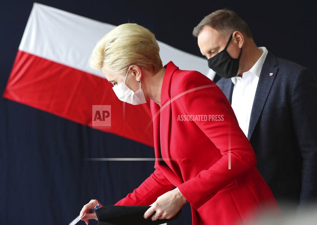 Czarek Sokolowski Candidate in Poland's tight presidential election runoff, incumbent President Andrzej Duda,right, and First Lady Agata Kornhauser-Duda ,left, cast their ballots at a polling station in their hometown of Krakow, Poland, on Sunday, July 12, 2020. Conservative Duda is running against liberal Warsaw Mayor Rafal Trzaskowski and latest opinion polls suggest the race will be decided by a very narrow margin.(AP Photo/Czarek Sokolowski)