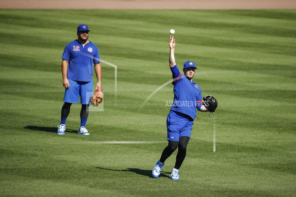 Kamil Krzaczynski Chicago Cubs center fielder Ian Happ, right, throws the ball during baseball practice as left fielder Kyle Schwarber, left, looks on at Wrigley Field on Friday, July 3, 2020 in Chicago. (AP Photo/Kamil Krzaczynski)