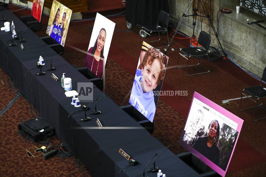 Hannah Mckay Images of people who've been helped by the Affordable Care Act (ACA) occupy the seats of Democratic senators boycotting a Senate Judiciary Committee business meeting on the nomination of Judge Amy Coney Barrett to be an associate justice of the U.S. Supreme Court, Thursday, Oct. 22, 2020 on Capitol Hill in Washington. (Hannah McKay/Pool via AP)