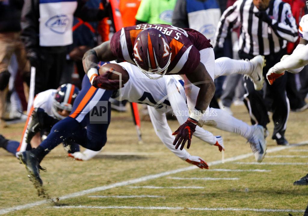 Steve Helber Virginia Tech running back Steven Peoples (32) gets stopped short of the goal line by Virginia safety Brenton Nelson (28) during the first half of an NCAA college football game in Blacksburg, Va., Friday, Nov. 23, 2018. (AP Photo/Steve Helber)