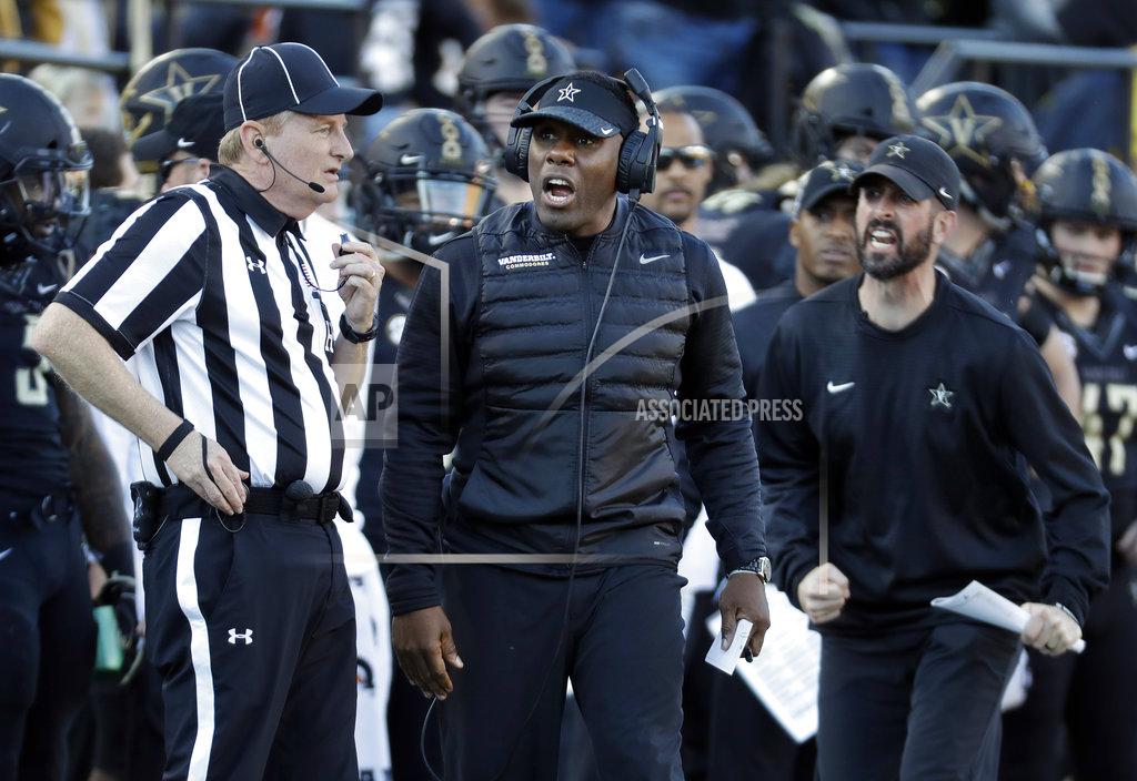 Mark Humphrey Vanderbilt head coach Derek Mason, center, argues a call in the first half of an NCAA college football game against Tennessee, Saturday, Nov. 24, 2018, in Nashville, Tenn. (AP Photo/Mark Humphrey)